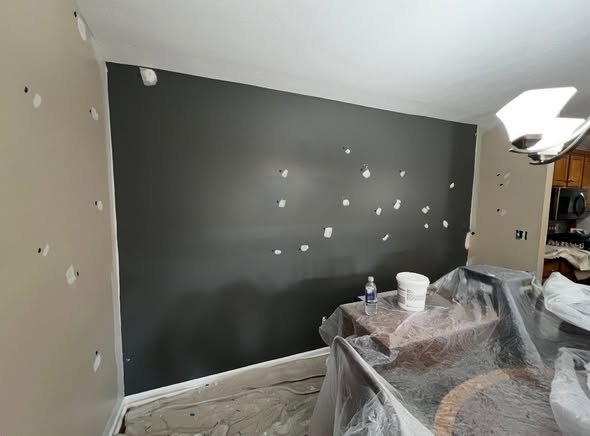 An interior repaint in progress with a fresh accent wall